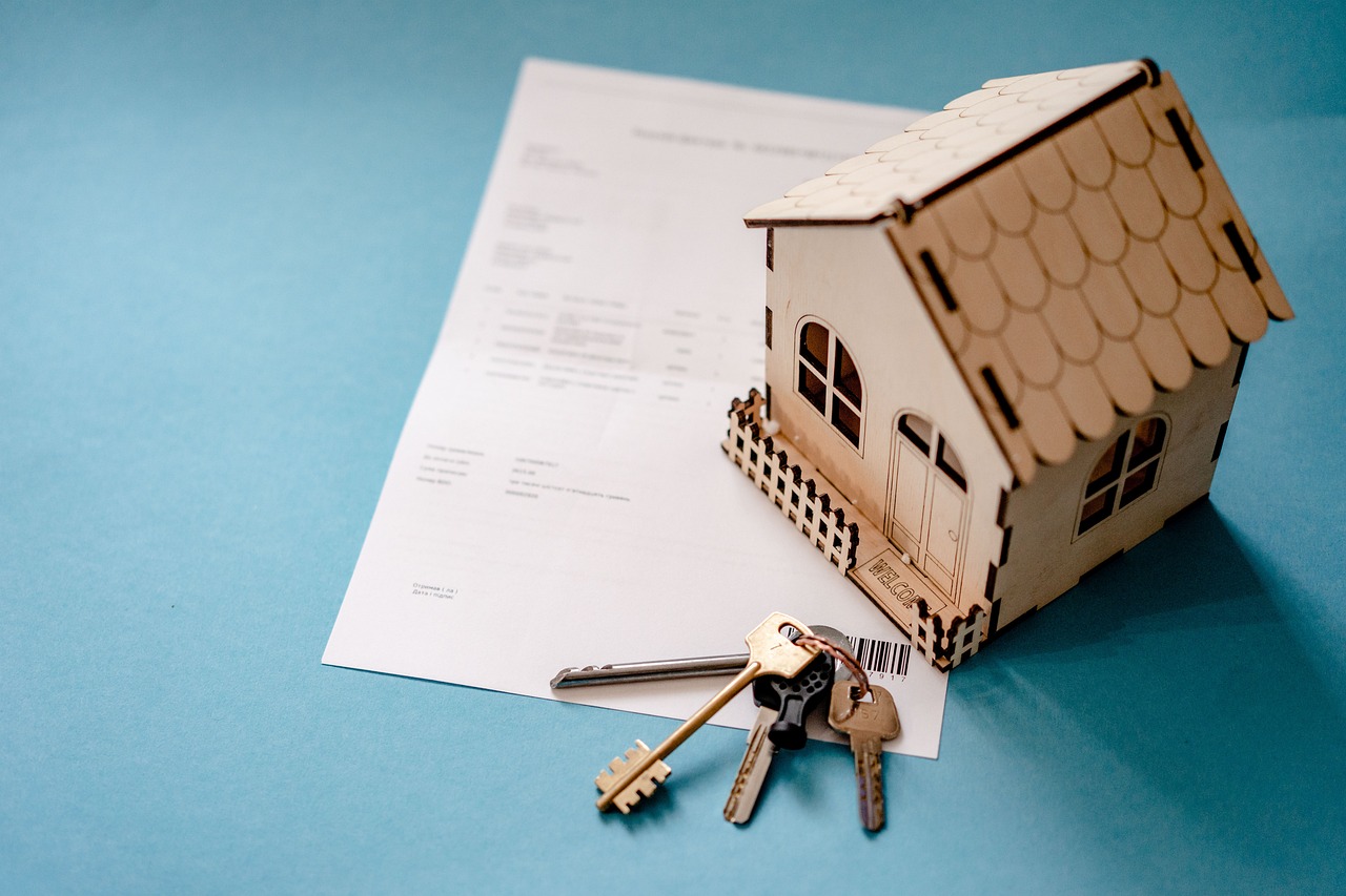 A landlord and tenant reviewing a printed lease agreement document on a wooden desk.